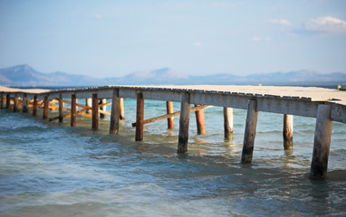 Fototapeta premium Old wooden pier leading to the sea.