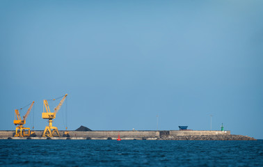 Fototapeta premium Yellow harbor cranes on rails in port.