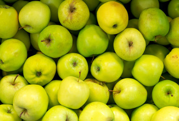 Lots of bright green apples in supermarket.