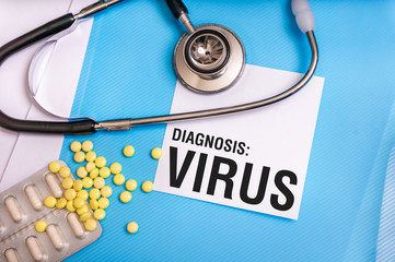 Virus word written on medical blue folder with patient files