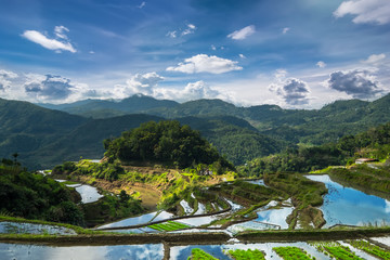 Amazing panorama view of rice terraces fields in Ifugao province mountains under cloudy blue sky....