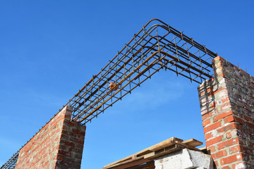 Rebar steel bars on new home construction corner, reinforcement concrete bars with wire rod as a lintel for window. 
