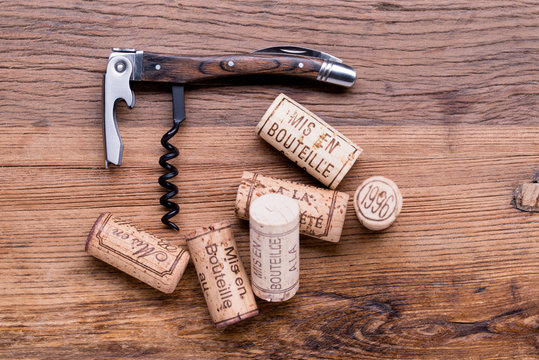 wine concept flat lay still life with corks and corkscrew on a oak wood table