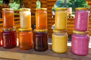 jars with honey on market.  Homemade honey. various jars of hone