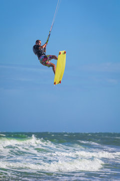 Athletic man jump on kite surf board sea waves
