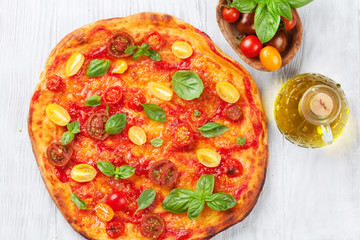 Pizza with tomatoes, mozzarella and basil