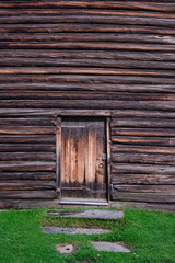 The wooden wall and door. Wood texture or background.