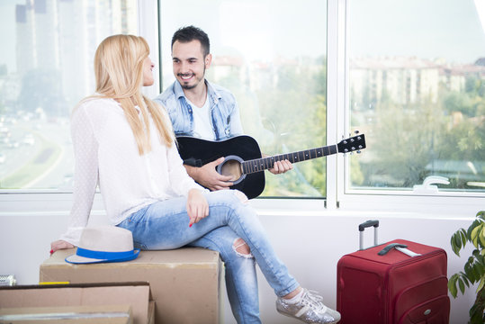 Young couple sitting and relaxing on box