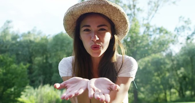 HTML5 Video is required for viewing the video 	On a sunny summer day a woman with a very cool hat is happy and sends a kiss smiling emanating joy and happiness