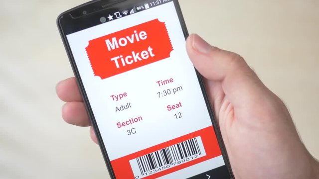 Movie theatre ticket showing on a smartphone screen. Digital eTicket.