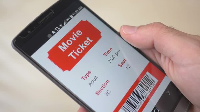 Movie theatre ticket showing on a smartphone screen. Digital eTicket.