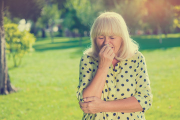 Fototapeta premium Senior woman crying. Upset female outdoors. Burst into tears. Bad mood after quarrel.