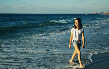 portrait of a real 10 years old girl walking on the beach