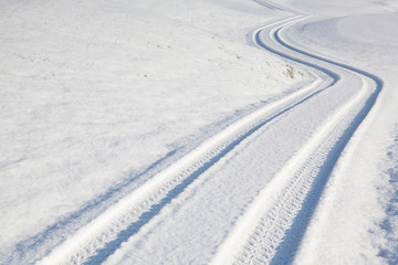Fototapeta na wymiar Car tire track on winter road