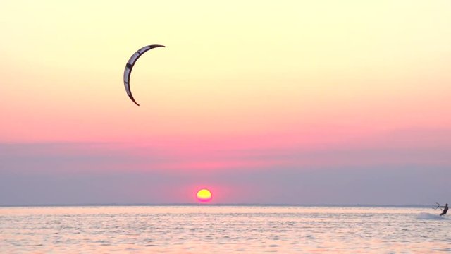 Kitesurf on the background of a beautiful sunset.   Slow motion 240 fps.