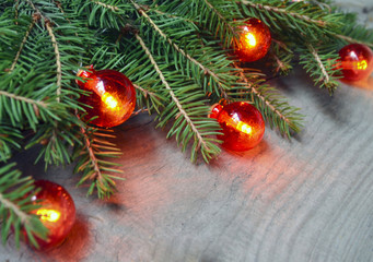 Christmas decoration with fir tree branch and red garland lights on wooden background. Merry Christmas, winter holidays,Happy New Year concept.Soft selective focus,copy space.