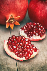 Ripe pomegranate fruit on grey wooden rustic background