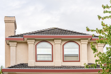 The top of the house or apartment building with nice window.