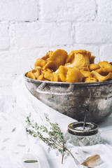 Chanterelles on vintage white wooden background top view, healthy food on table mockup, orange mushrooms isolated on rustic country board, fresh forest nutrition mock up closeup, copy space for text