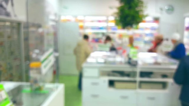 Pharmacy interior with customers, blurred background