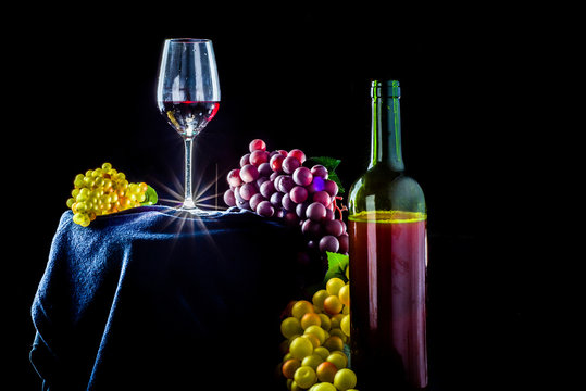 Glass Of Red Grapes On A Black Background