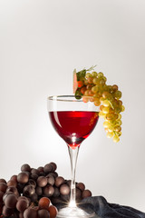 glass of red grapes on a light background