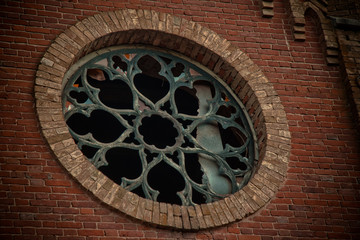 Round castle window with broken stained-glass windows