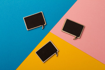 Square empty chalk board speech bubbles on colored papers