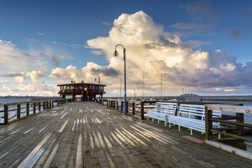 A wooden pier in Puck town on coast of Baltic Sea. Bay of Puck in Poland. Europe. - obrazy, fototapety, plakaty