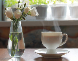 a Cup of tea and a bouquet of white flowers