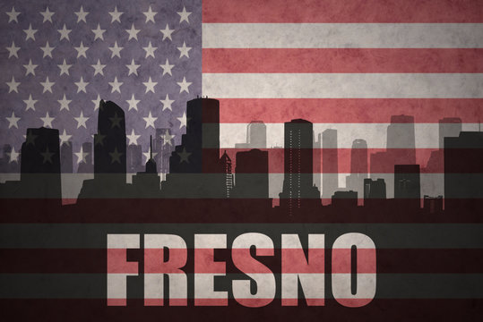 abstract silhouette of the city with text Fresno at the vintage american flag