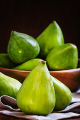 Fresh green figs, still life in rustic style, vintage wood backg
