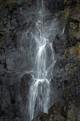 Fototapeta na wymiar Close-up of flowing water at a waterfall