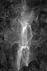 Close-up of flowing water at a waterfall in black & white.