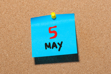 May 5th. Day 5 of month, calendar on cork notice board, business background. Spring time, empty...