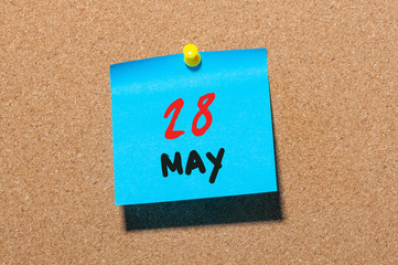 May 28th. Day 28 of month, calendar on cork notice board, business background. Spring time, empty space for text