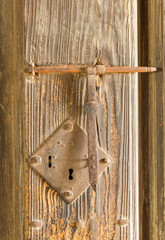 Antique rusty door lock on timber