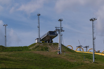 Fototapeta na wymiar Ski lift, summer, sun, green grass.