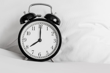 Still life with vintage alarm clock on bed ( alarm clock show 8