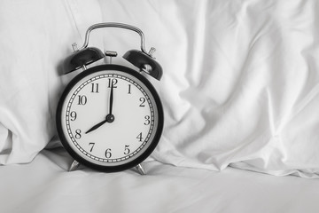 Still life with vintage alarm clock on bed ( alarm clock show 8