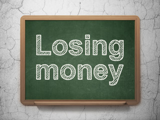 Money concept: Losing Money on chalkboard background