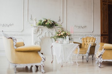Wedding decorations zone - white table with bouquet and cupcakes