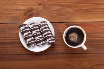 Coffee and cookies on a wooden table.