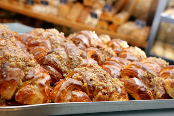 Fresh croissants out of the oven and decorated with icing and wa