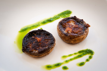 Fried mushrooms on a white plate .