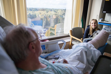 Elderly patient at hospital visited by grandchild
