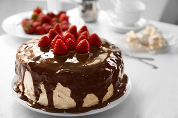 Cake with caramel and strawberries on table