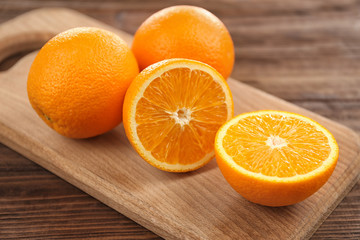 Fresh oranges on cutting board