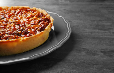 Delicious cake with nuts on table