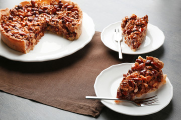 Delicious cake with nuts on table